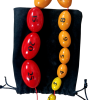 Orquidómetro de Prader original, de 12 esferas sobre bolso de pana negro, utilizado para medir volumen testicular en entornos clínicos.